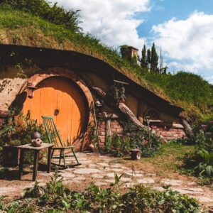 Hobbit style home New Zealand countryside, representing lifestyle, culture, tourism and unique living experience for UK expats relocating to New Zealand.