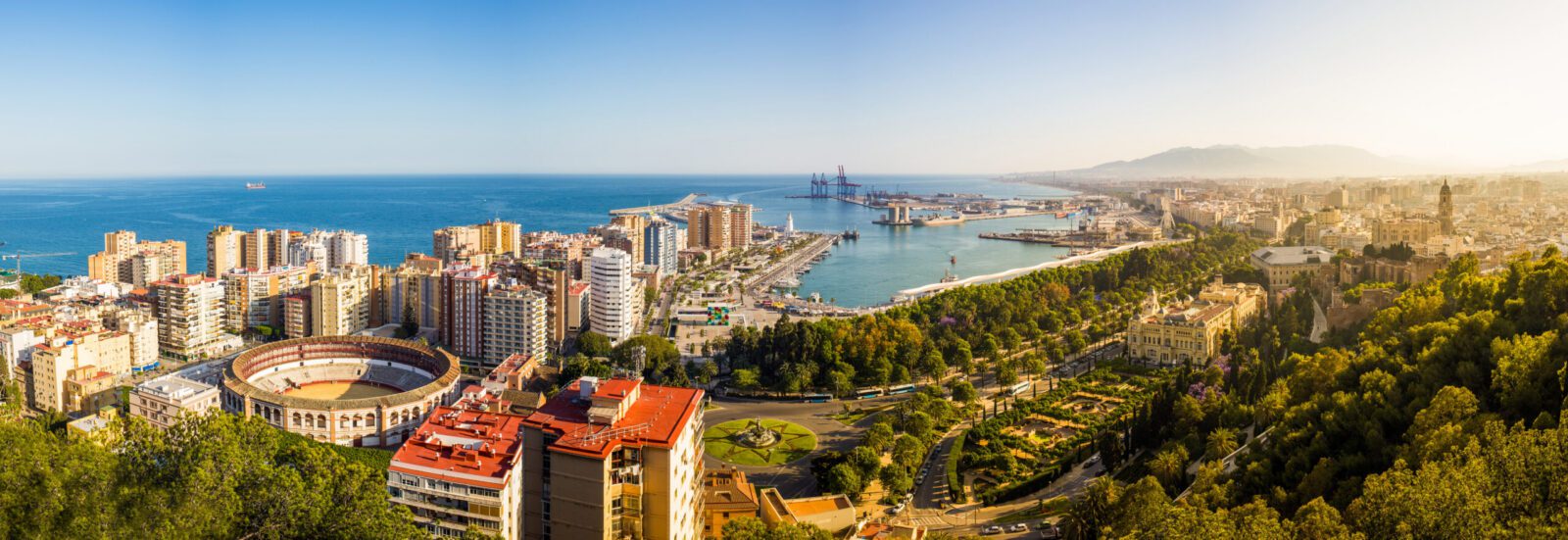 Costa del Sol coastline with Malaga city skyline and Mediterranean sea, representing best regions to live in Spain, coastal living and UK expat destinations for UK nationals moving to Spain from UK.