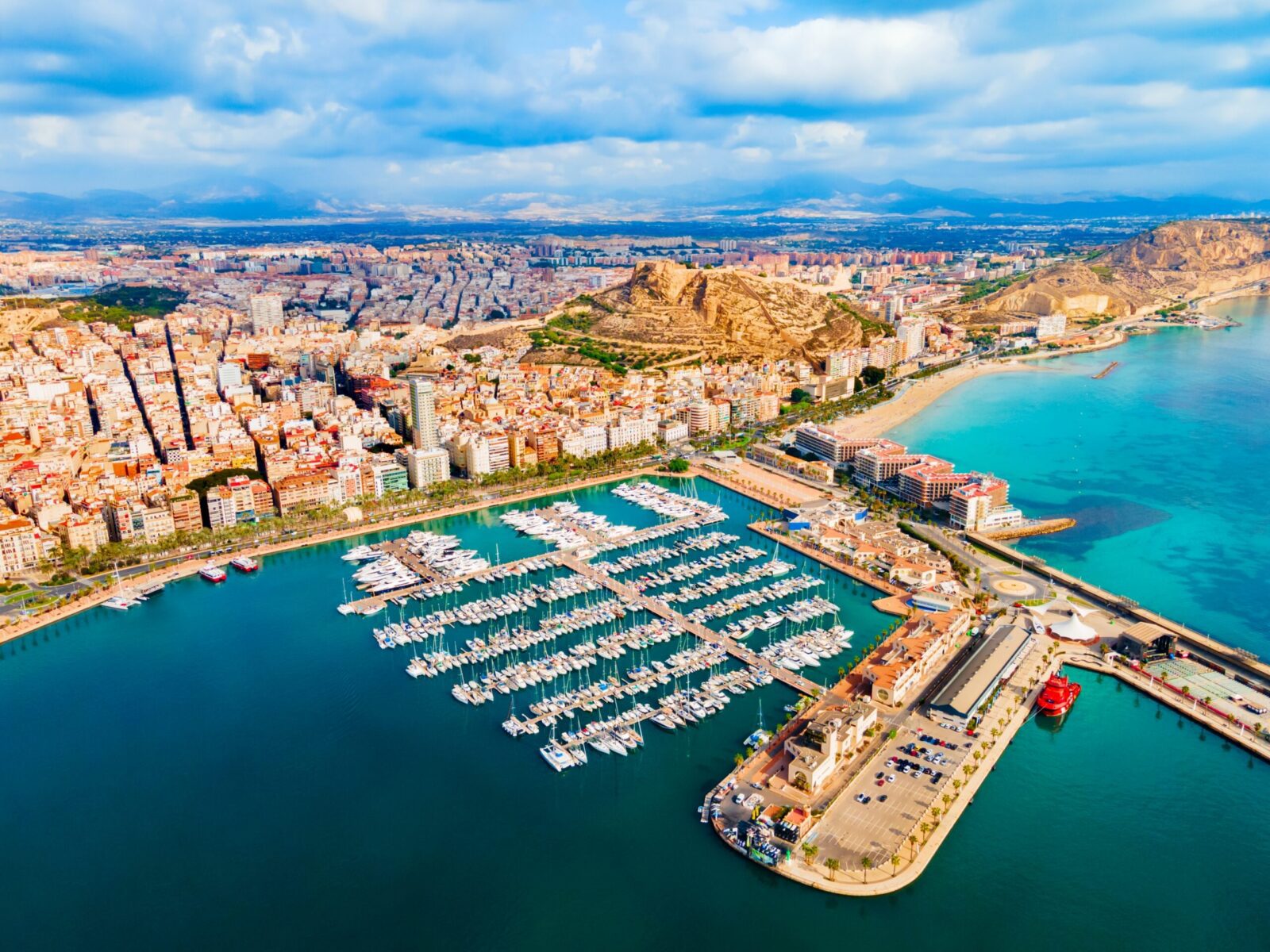 Aerial view of Alicante marina and coastline in Spain, representing best regions to live in Spain, affordable coastal living and UK expat destinations for UK nationals moving to Spain from UK.