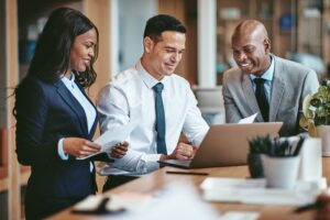 Business executives reviewing financial plans representing tailored wealth strategies for UK expat entrepreneurs.