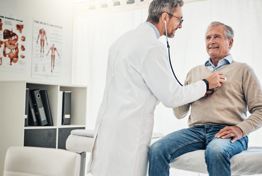 Doctor examining a British expat during a routine medical consultation in a modern private healthcare clinic in Turkey.