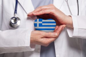 Doctor holding heart with Greek flag symbolising healthcare access for UK expats moving to Greece from UK and securing insurance for residency.