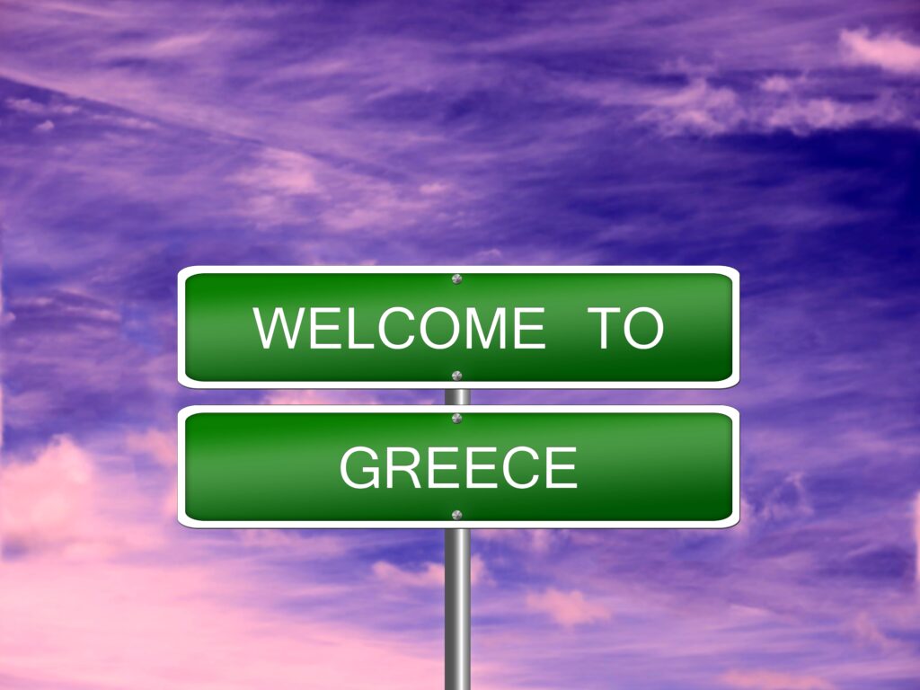 Welcome to Greece sign representing relocation and residency options for UK nationals moving to Greece from UK including Golden Visa Greece pathway.