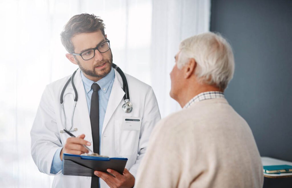 Doctor discussing treatment options with a British retiree during a private healthcare consultation in Turkey.