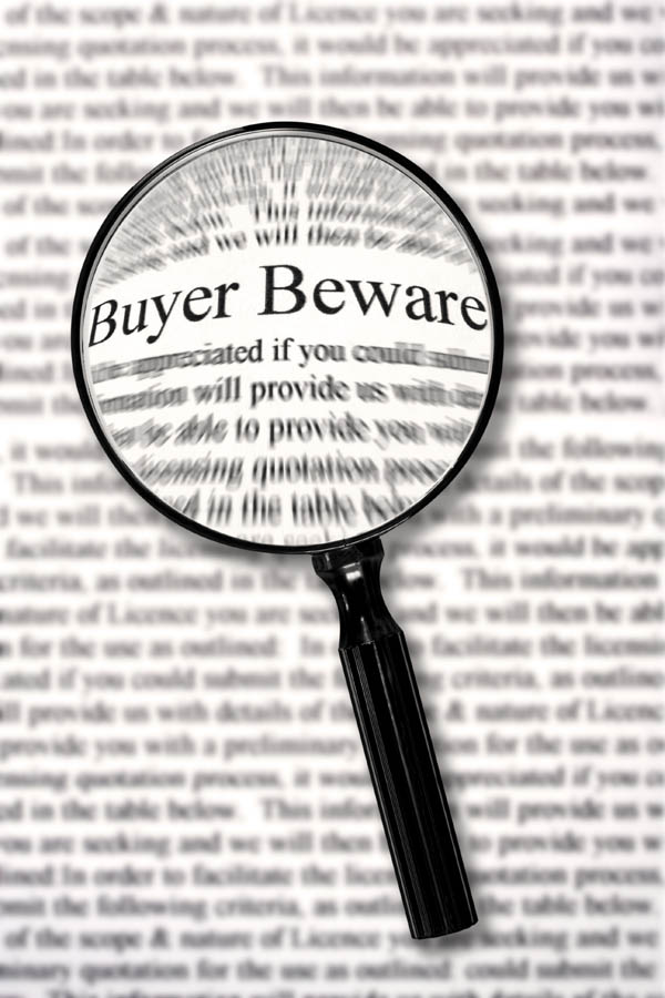 Magnifying glass highlighting the words "Buyer Beware", illustrating the importance of legal due diligence, developer checks and risk assessment before buying off-plan property in Turkey for Turkish Citizenship by Investment.