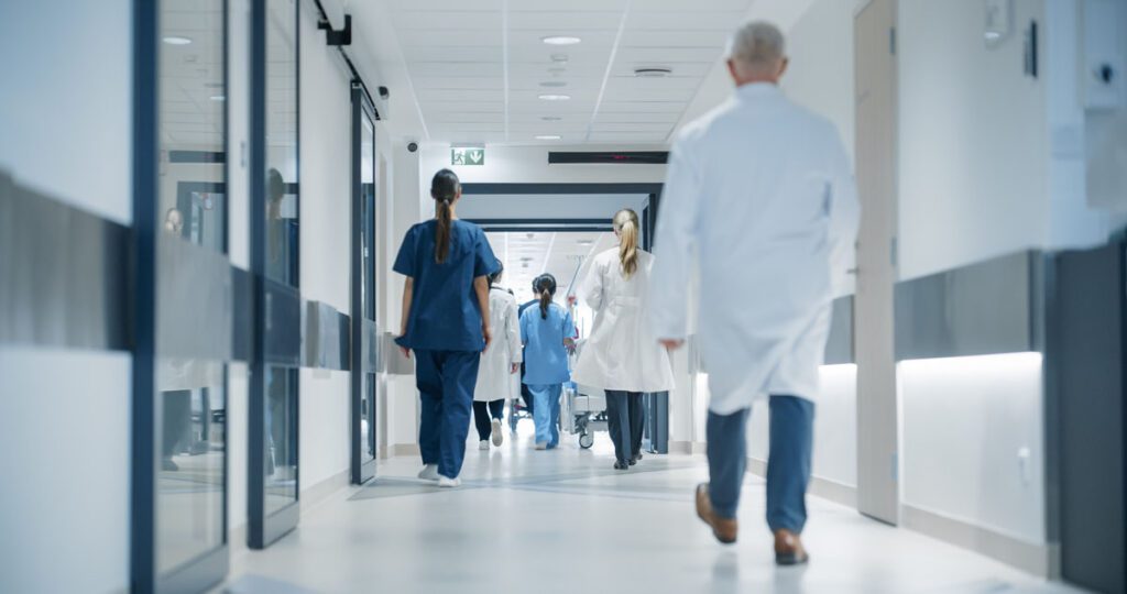 Modern private hospital corridor in Turkey with doctors and medical staff, illustrating the high standard of healthcare available to British expats and international patients.