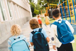 Children walking to school with backpacks representing education options in Albania for UK expat families relocating from the UK.