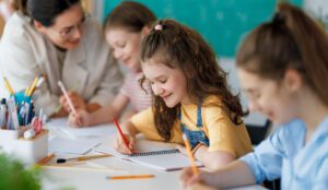Children in classroom in Italy with teacher, representing schools in Italy for UK families, education options and international schools for UK expats.