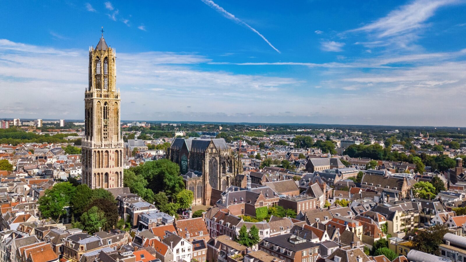 Eindhoven city skyline with modern buildings and historic architecture, representing innovation hub, affordable living and job opportunities for UK expats in the Netherlands.