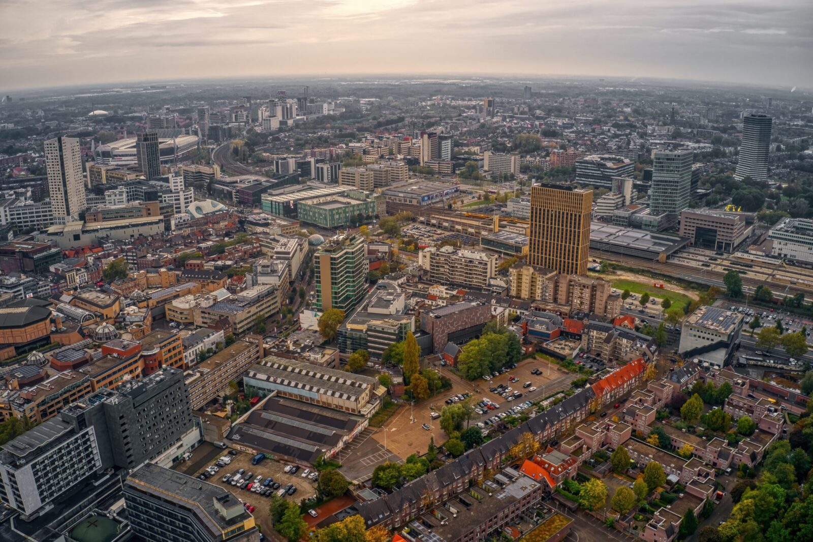 Aerial view of Utrecht city with canals, historic buildings and modern skyline, representing balanced lifestyle, affordability and relocation for UK expats in the Netherlands.