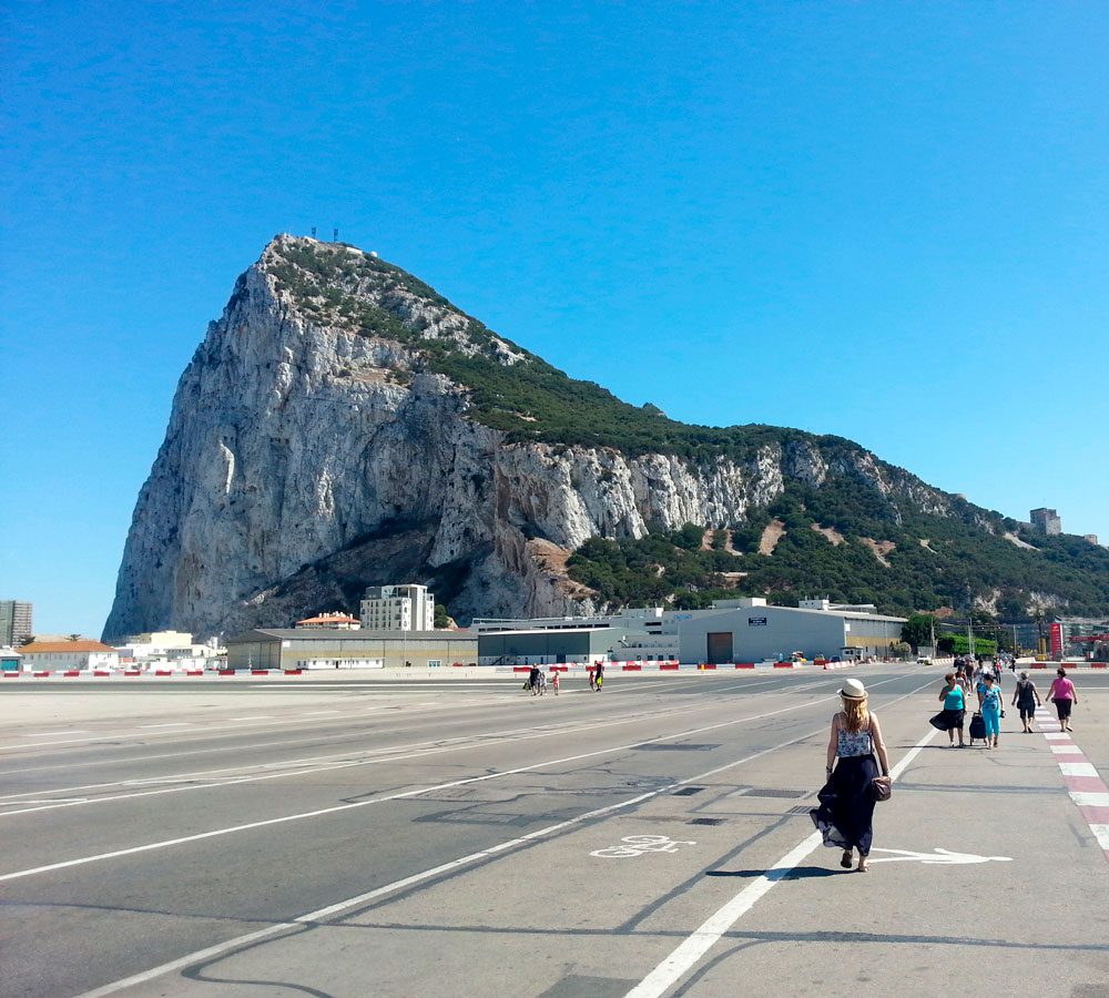 Pedestrians and traffic sharing a busy street in Gibraltar.