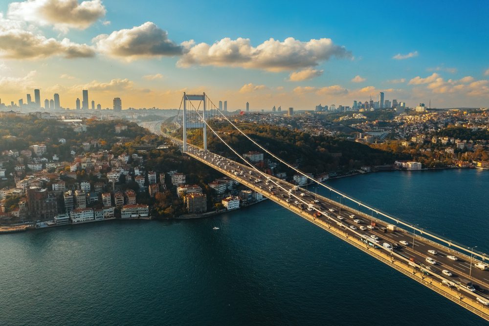 Bosphorus Bridge and Istanbul skyline at sunrise, illustrating modern infrastructure and the safe, vibrant lifestyle attracting British expats moving to Turkey.
