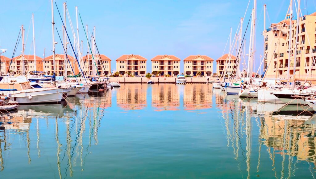 Waterfront homes and marina in Gibraltar accompanying house price and property buying guidance for UK expats.