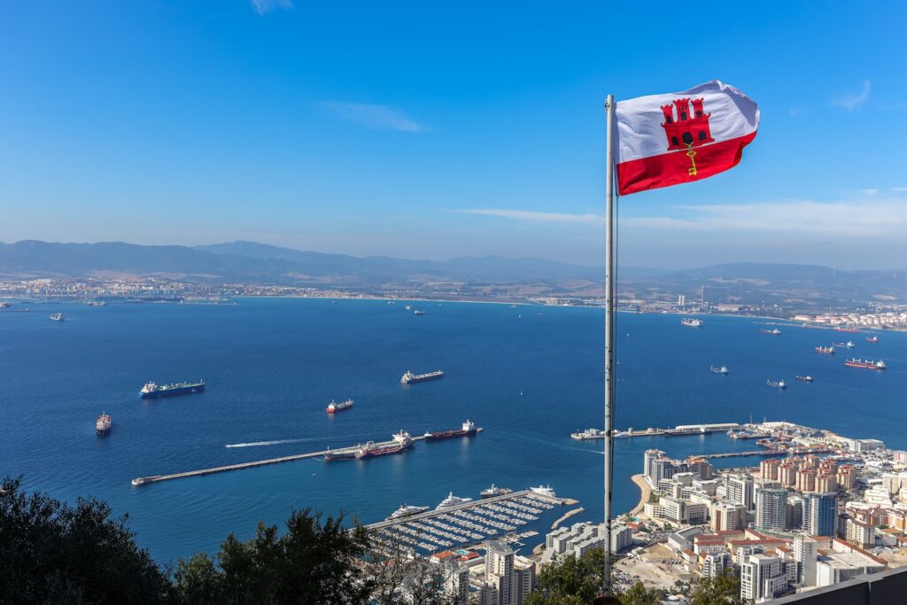 Gibraltar flag overlooking the Bay of Gibraltar accompanying guidance on UK and Gibraltar tax residence rules.